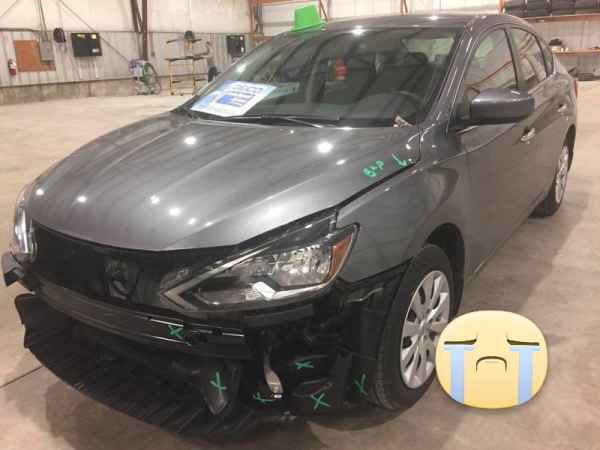 Black sedan with front-end collision damage before repair at Burnside Express Collision Greenwood Indiana auto body shop.