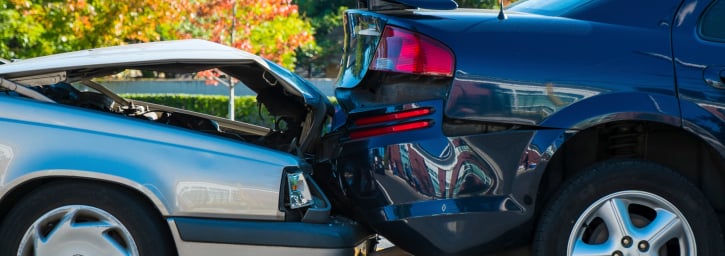 Two vehicles involved in a rear-end collision showing bumper damage before repair at Burnside Express Collision Greenwood Indiana.